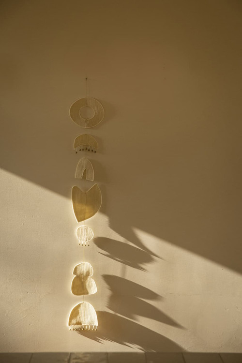 Beige 7 chakras mobile hanging on the wall for a soothing decoration