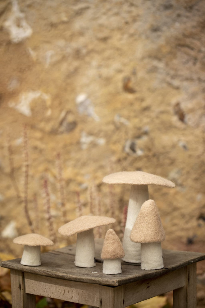 Woolen mushrooms on a wooden table as a decorative object