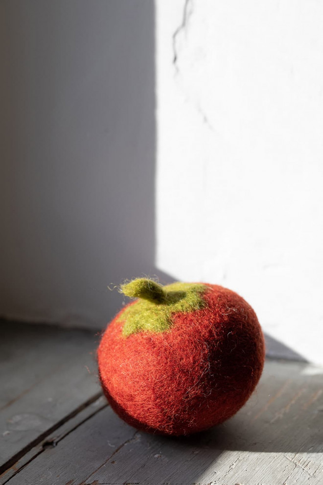a woolen tomato felted by hand