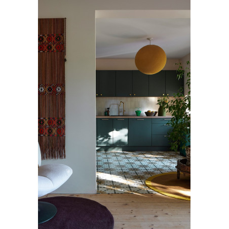 Living room opening onto a kitchen with cement tiles