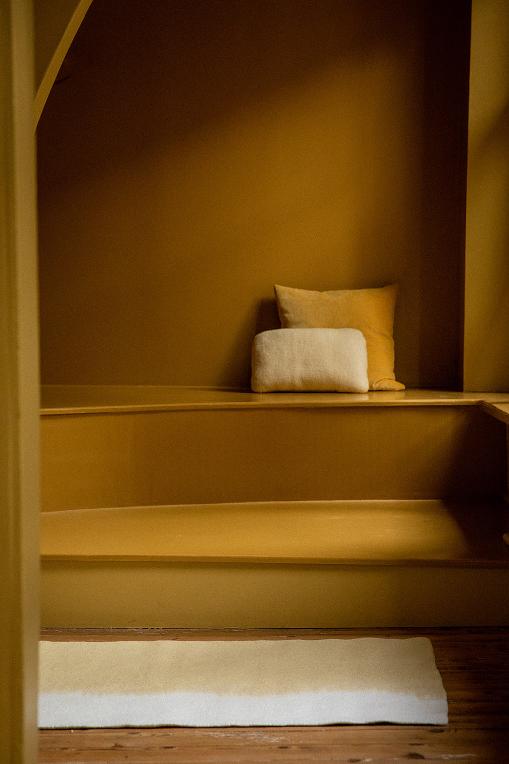 Yellow and white wool felt carpet for a soft decoration