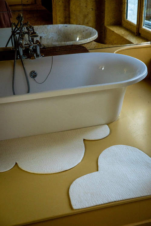 Two wool felt cloud bath mats for the bathroom