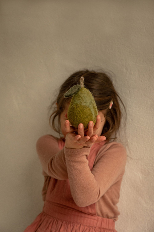a child holds a soft woolen pear