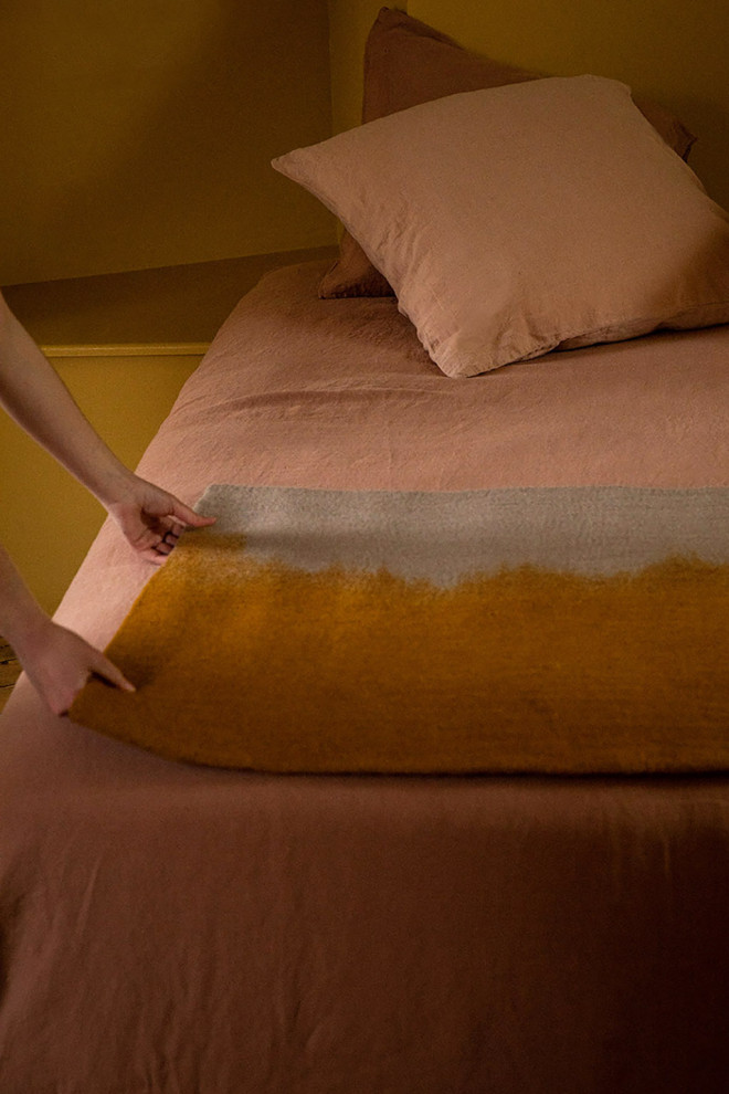 Pink and white rectangle felt carpet held by a woman