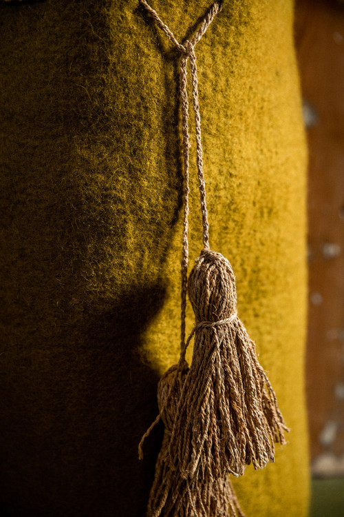 close-up on the natural material of this felt basket and its hemp ties