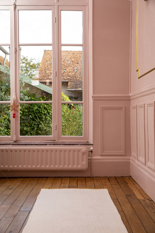 White rectangular wool felt carpet in front of a window White rectangular wool felt carpet in front of a window