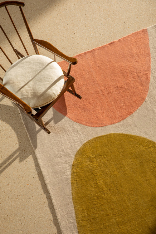 Large woolen carpet bouille rectangle in a living room with armchair