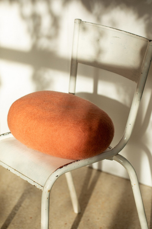 Felt oval cushion on a chair