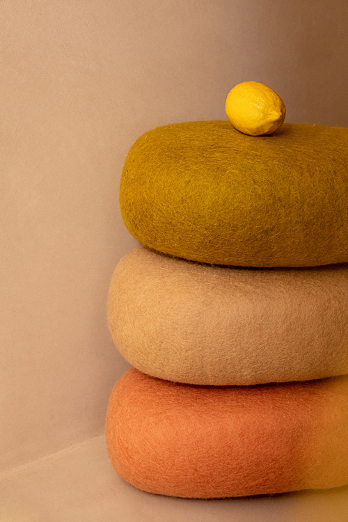 Pile of oval wool cushions in a warm atmosphere