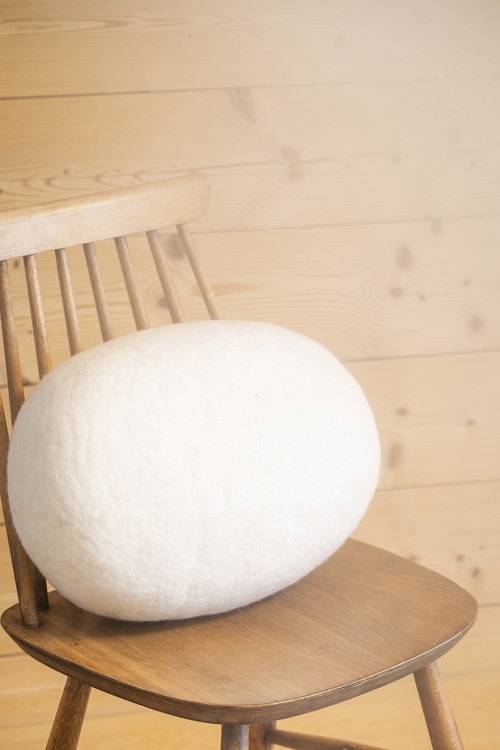 Natural felt cushion on a wooden chair