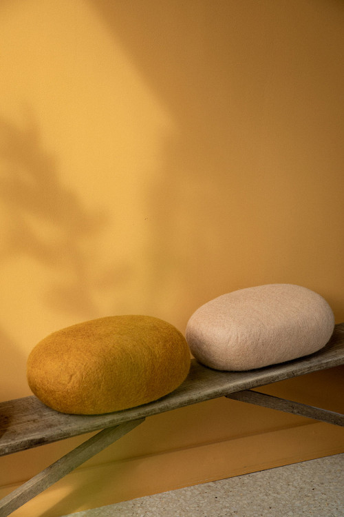 Duo of felted wool cushions on a bench