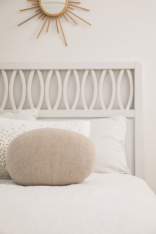 Oval chakati cushion on a bed