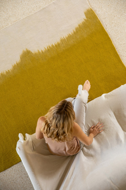 Large rectangle green and gray natural felt carpet in a living room