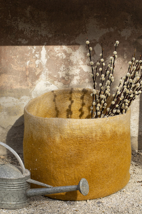 flowers arranged in an ochre and beige basket