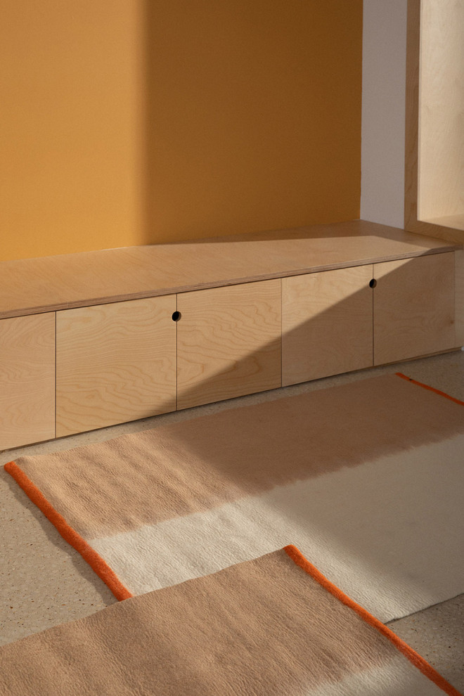 Tapis rectangulaire en feutre de laine blanc vert et rose suspendu à une porte