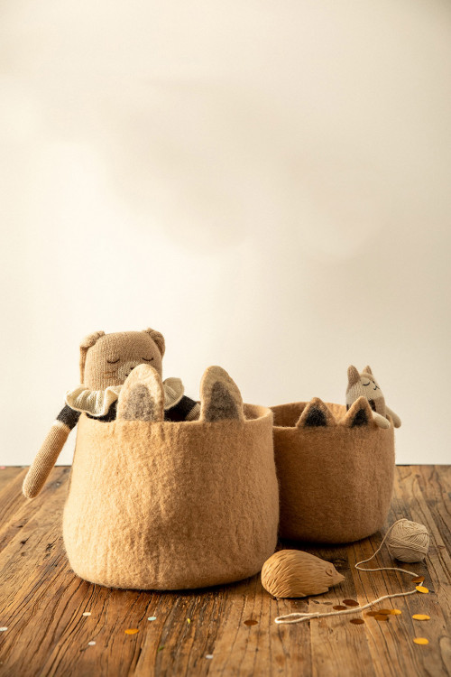 a child's treasures stored in felted animal baskets