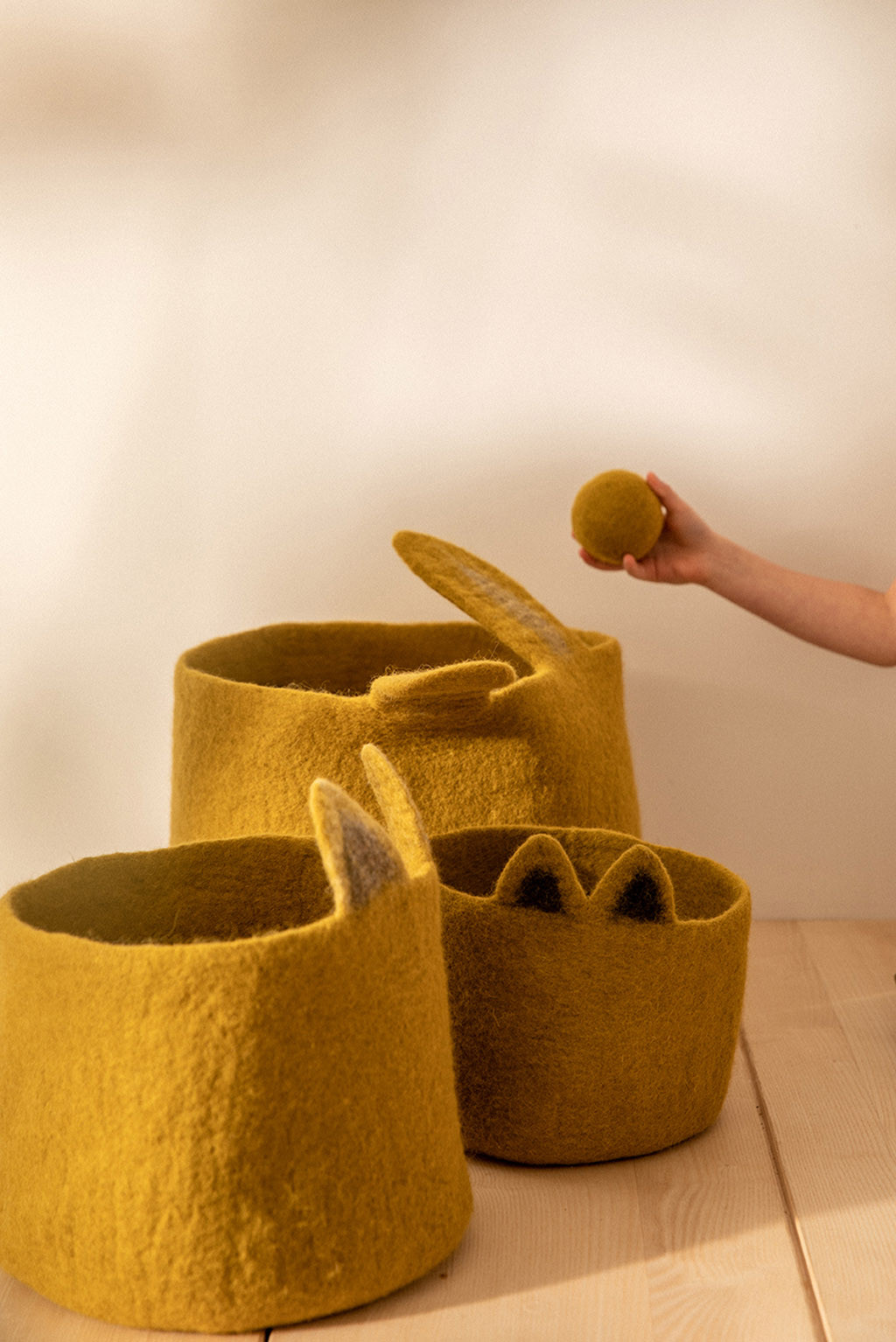 trio of ochre felt baskets to decorate a child's room