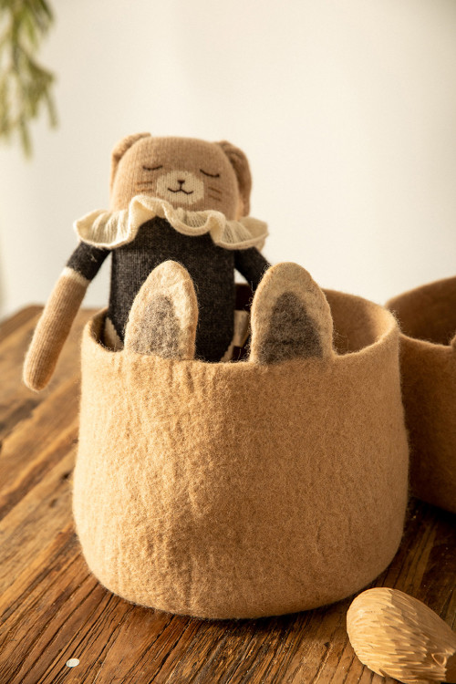 a comforter stored in its felt basket a comforter stored in its felt basket