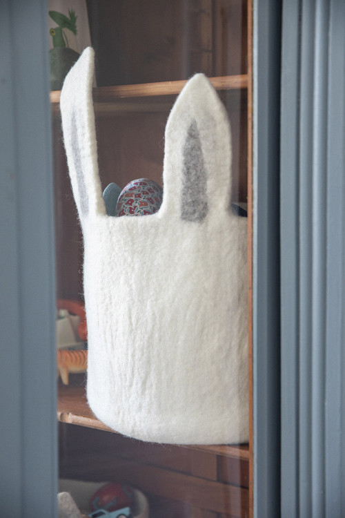 a basket with large rabbit ears stored in a child's bedroom closet