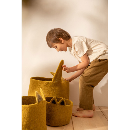 a child stores his toys in a bunny basket