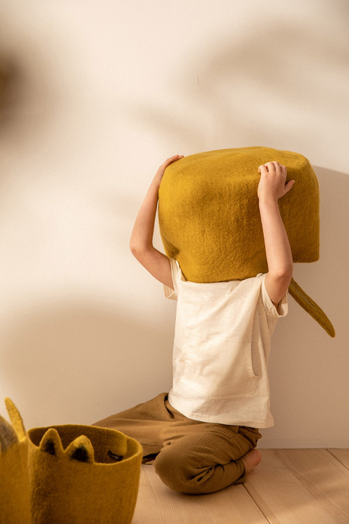 a child plays with his rabbit-shaped felt storage basket