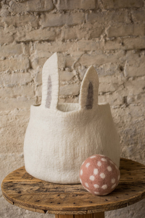 a storage basket with large rabbit ears for a baby gift