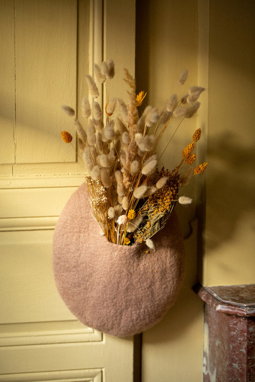 a pink boiled wool basket with dried flowers