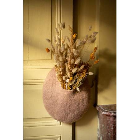 a pink boiled wool basket with dried flowers