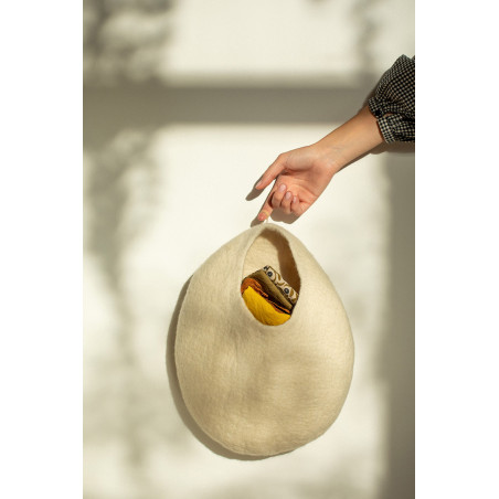 a white wool storage basket to hang anywhere in the house