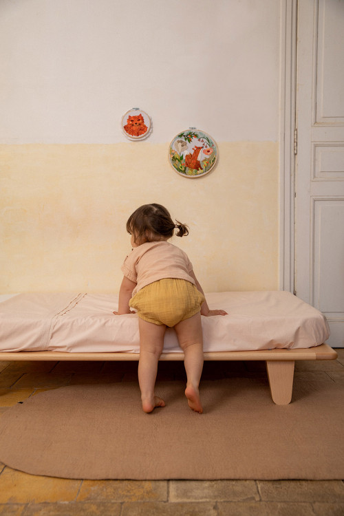 Light pink oval wool carpet for a child's room