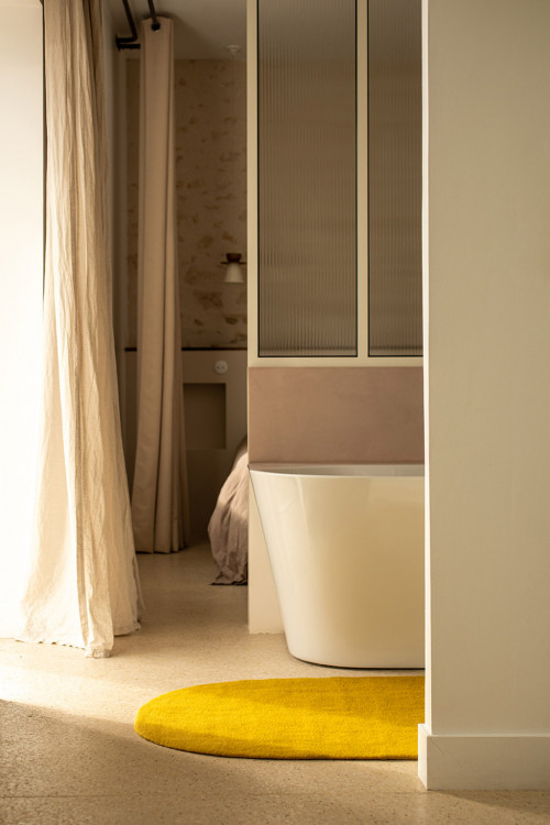 Green wool felt oval carpet in a bathroom