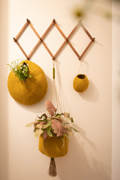 3 hanging storage baskets at the entrance of a house for a warm decoration