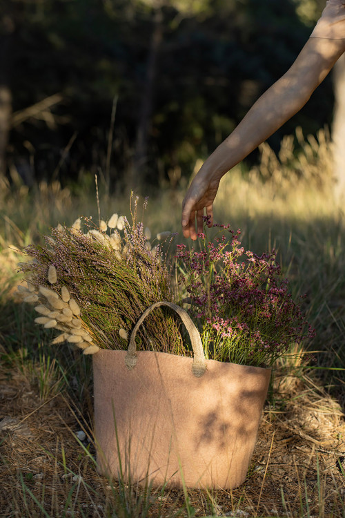 field flowers in a pink felt bag