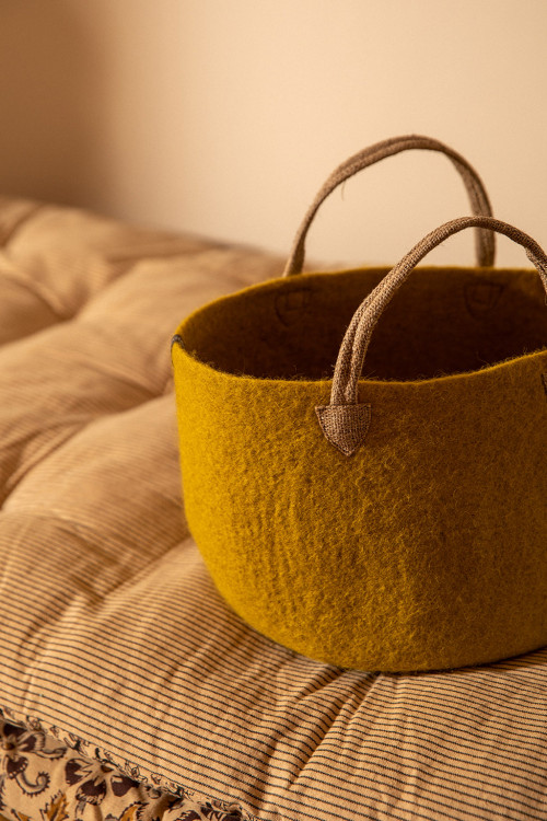 a bag with hemp handles placed on the bed