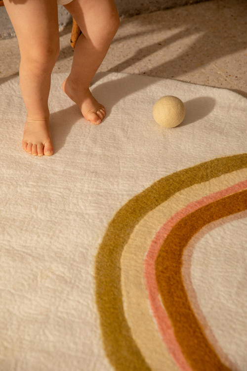 Round white wool felt carpet with colorful rainbow pattern for children