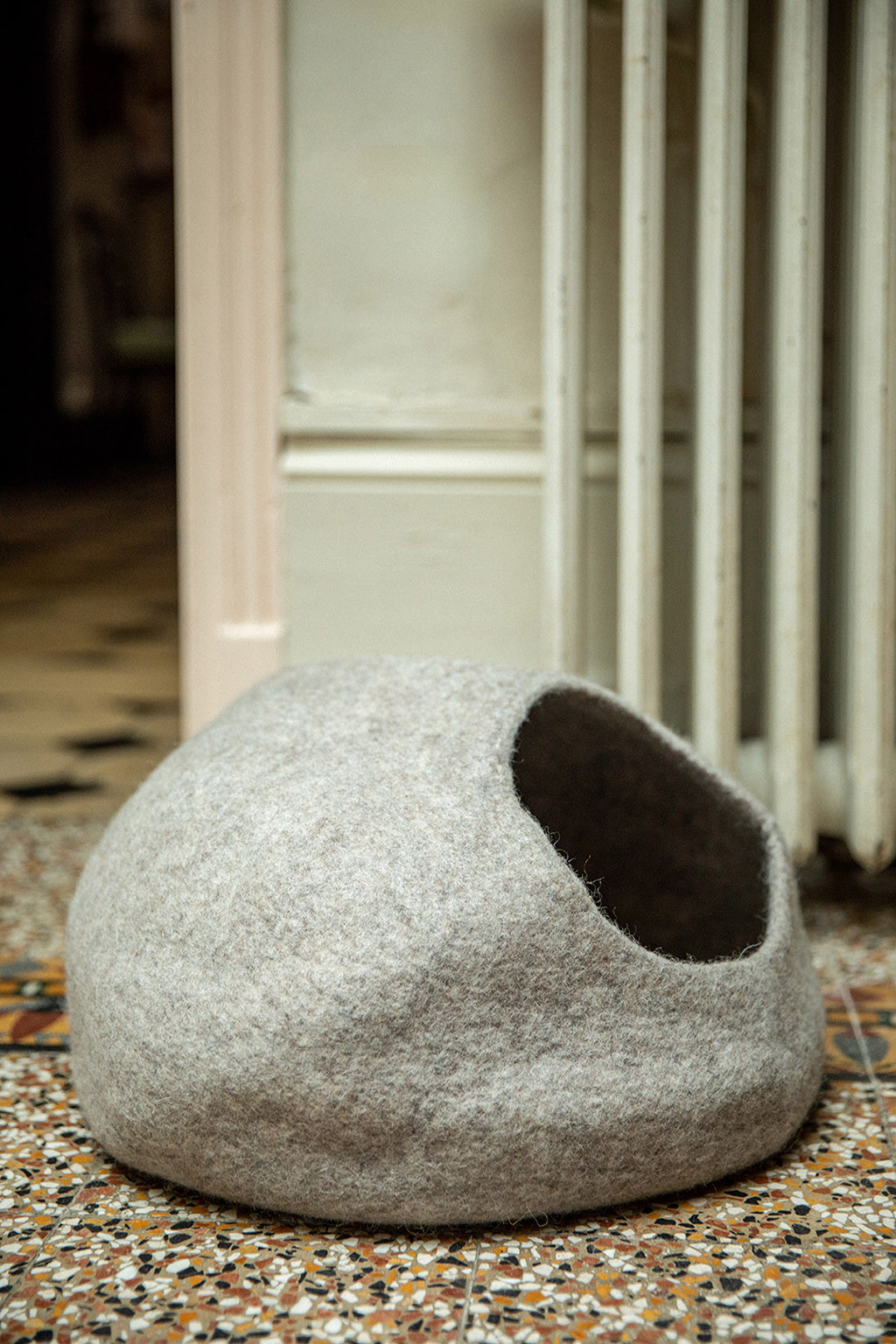 the organic shape of this felt cat basket also decorates the living room