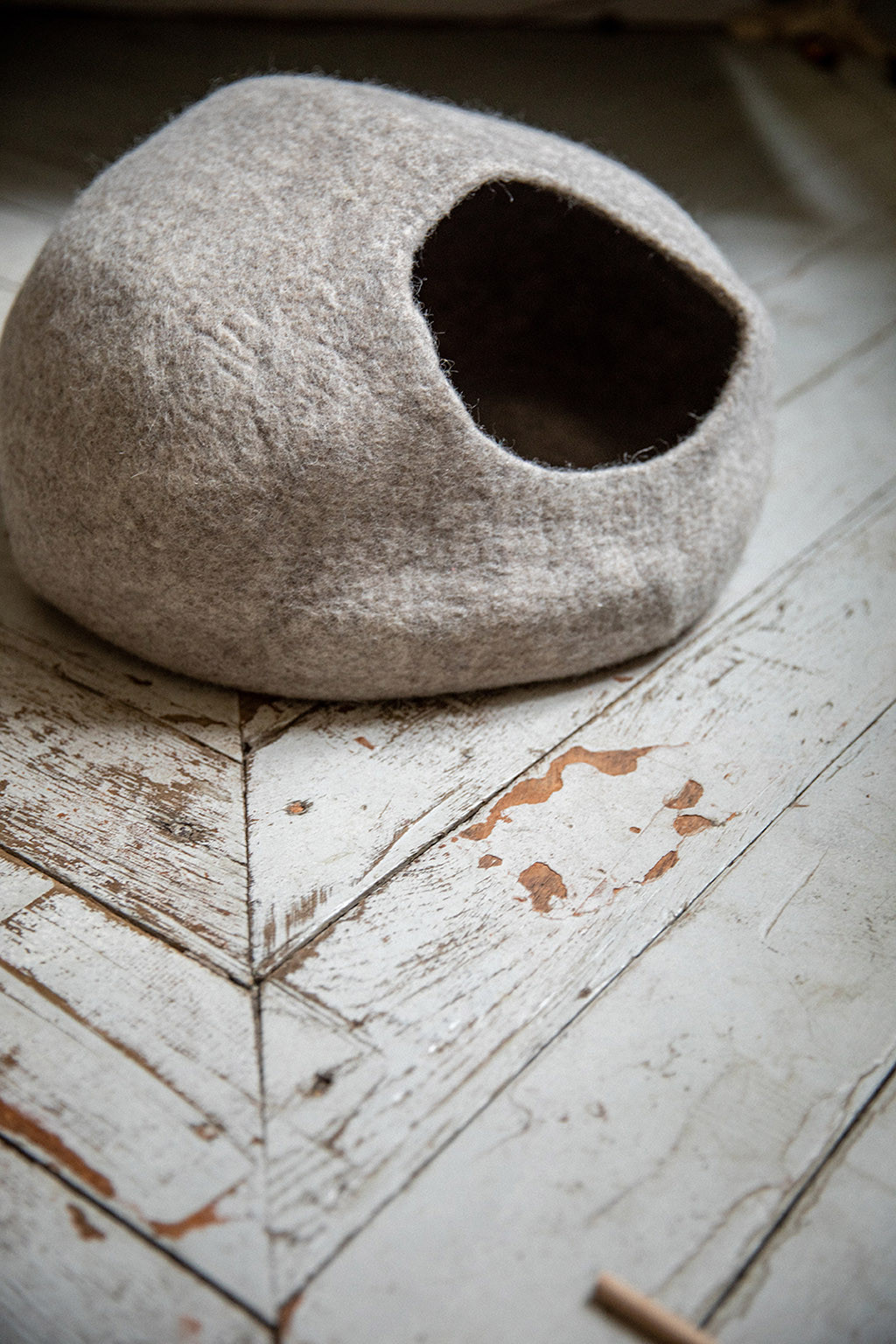 a grey felt basket on the floor