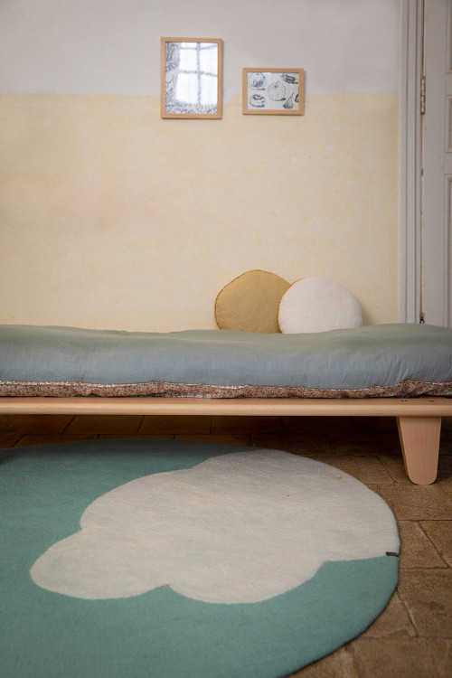 Round blue boiled wool carpet with cloud print for a child's room