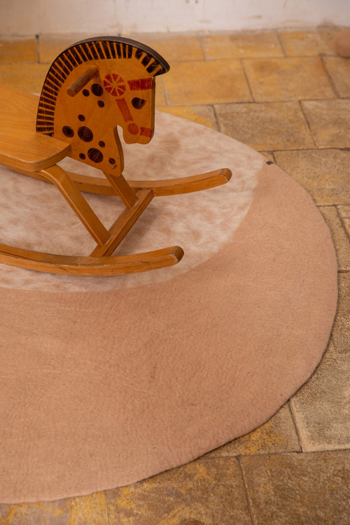 Round pink felt carpet for children with moon pattern