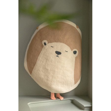 Little girl carrying a white and pink wool felt bear rug