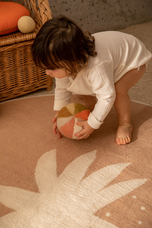 Colorful felt ball and round pink wool felt palm tree rug for a child's room