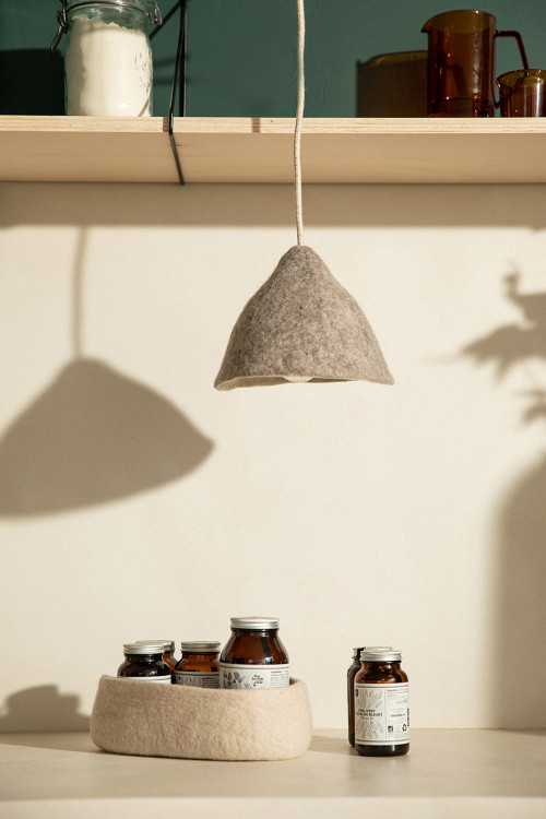 A small suspension made of felted wool as a trendy accent lamp