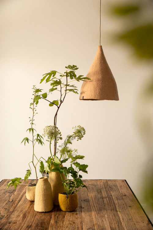 A perforated wool felt lampshade over the dining room table