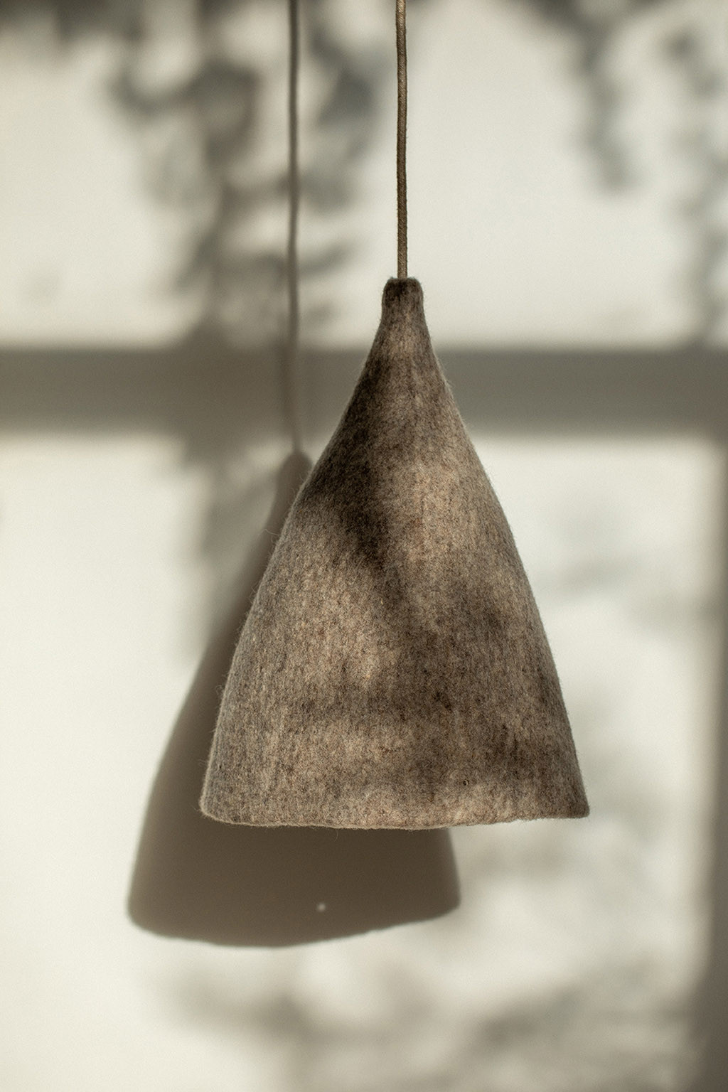 A reversible lampshade in grey and beige wool felt