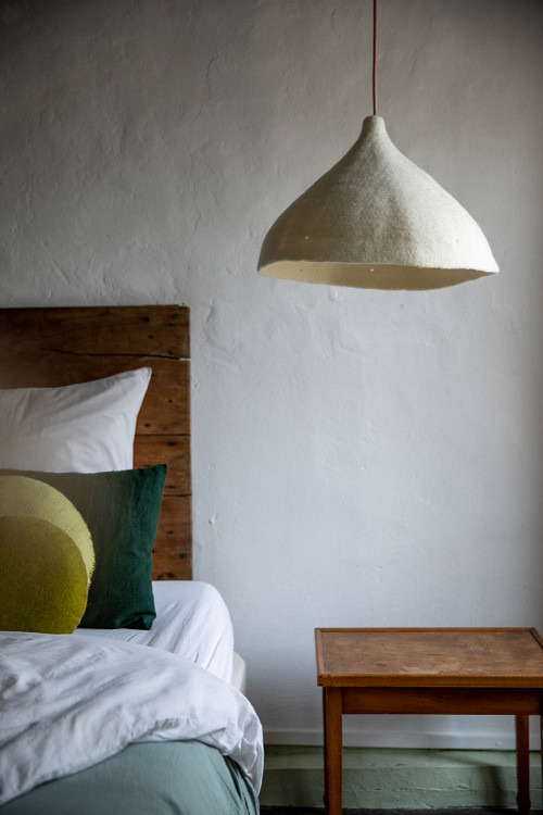 A felt hanging light as a bedside lamp in the bedroom