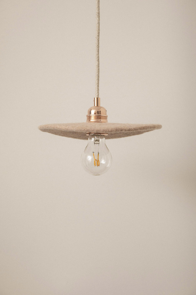 Une suspension lumineuse blanche au-dessus de la table de salle à manger