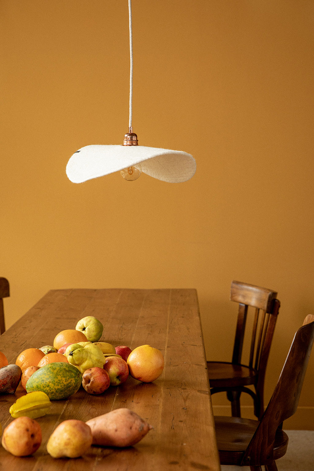 A white ceiling light above the dining room table