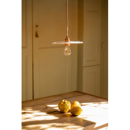 Felt ceiling lamp and raw wood table for an authentic dining area
