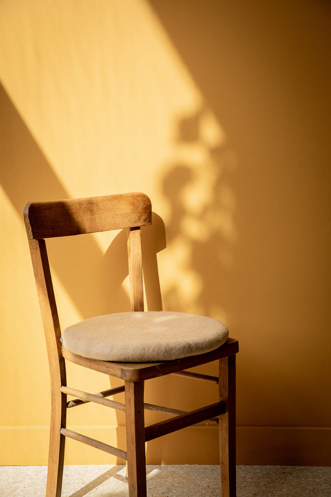 Felt ball placed on a pile of chair cushions.