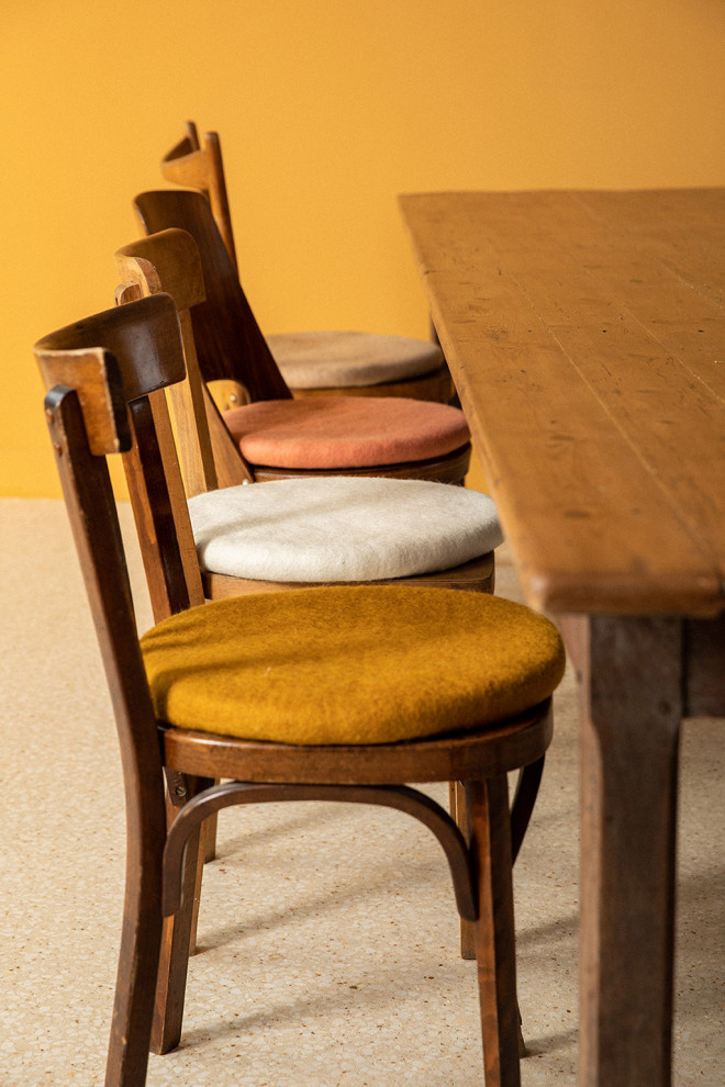 Felt ball placed on a pile of chair cushions.